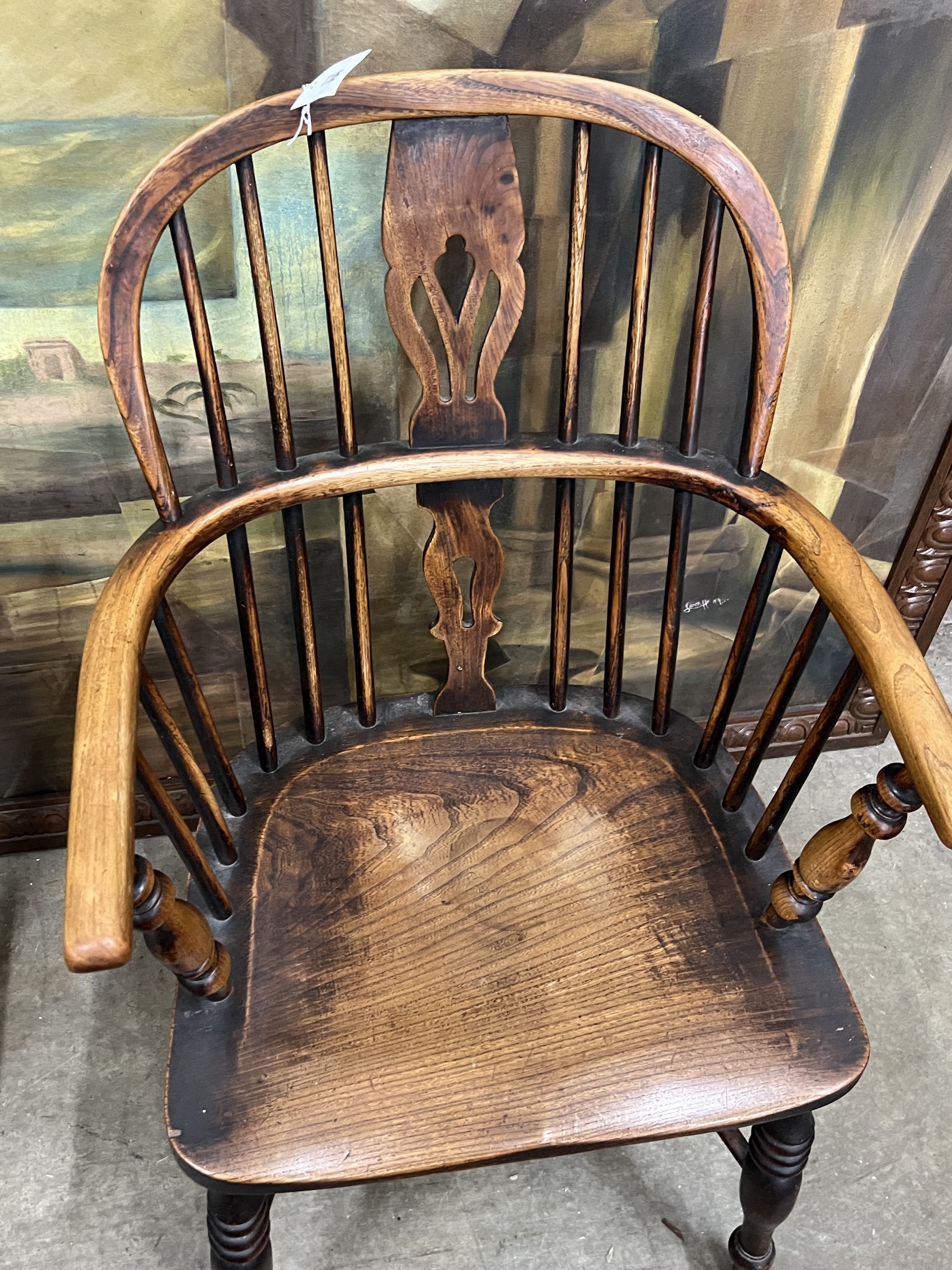 A 19th century Windsor ash and elm comb back elbow chair with crinoline stretcher, width 54cm, depth 40cm, height 94cm